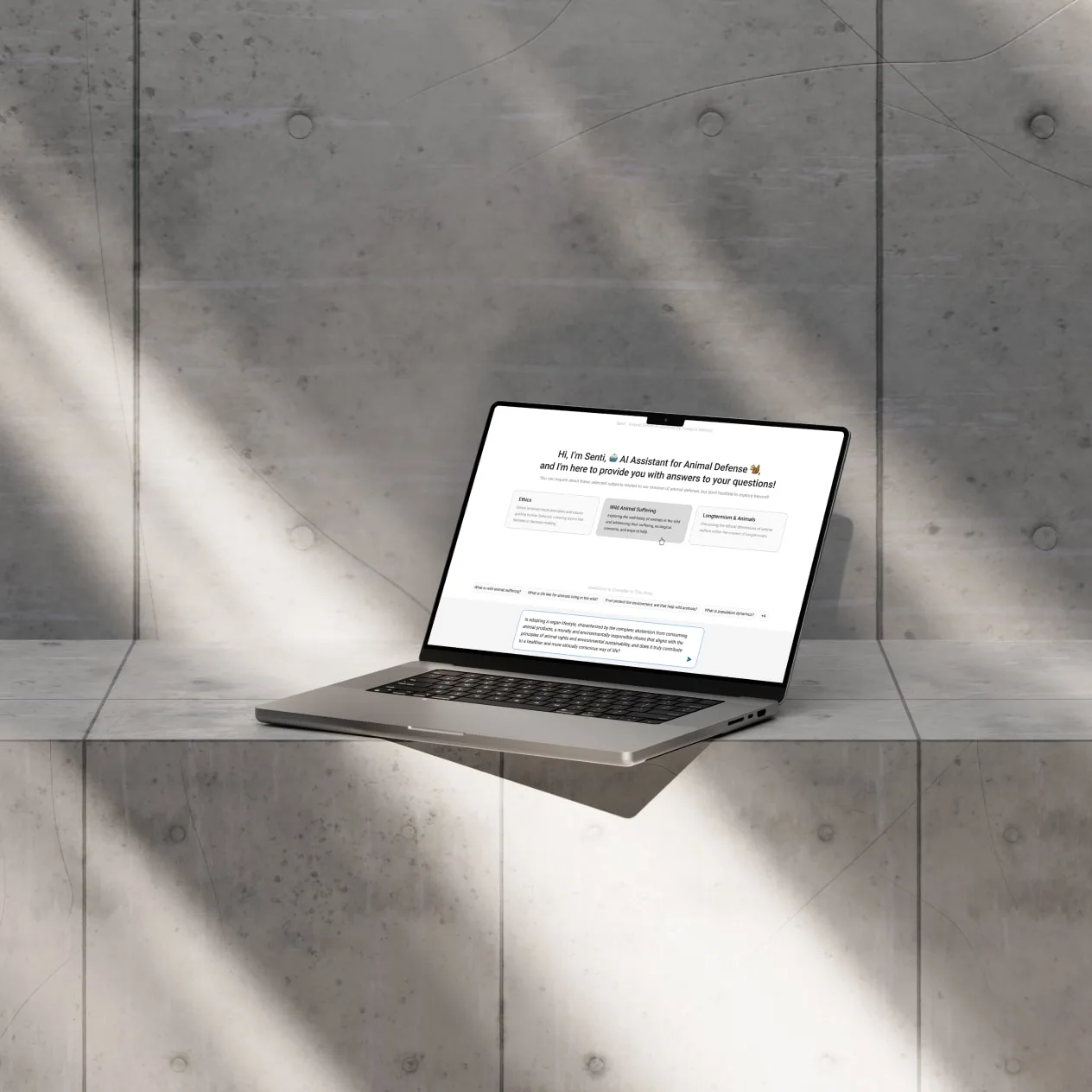 A longer user question being composed on a laptop, with suggested questions above the input